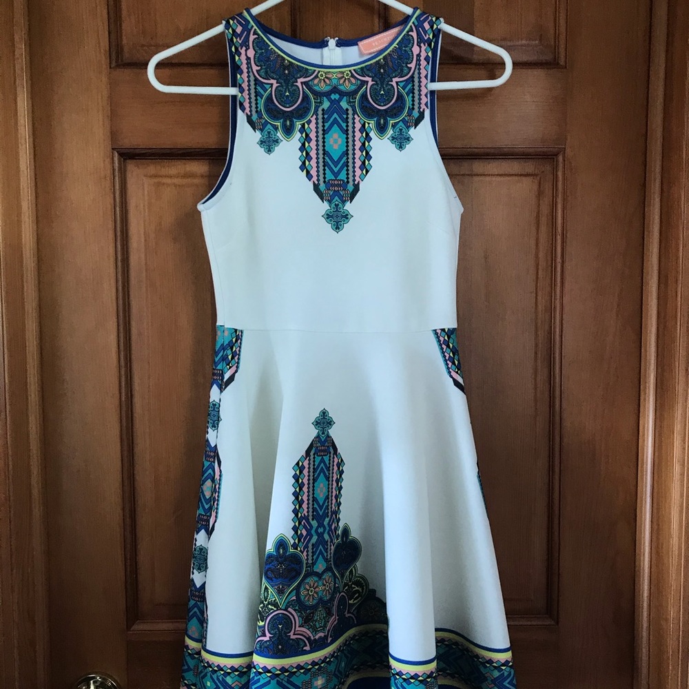 White dress with colorful print detail